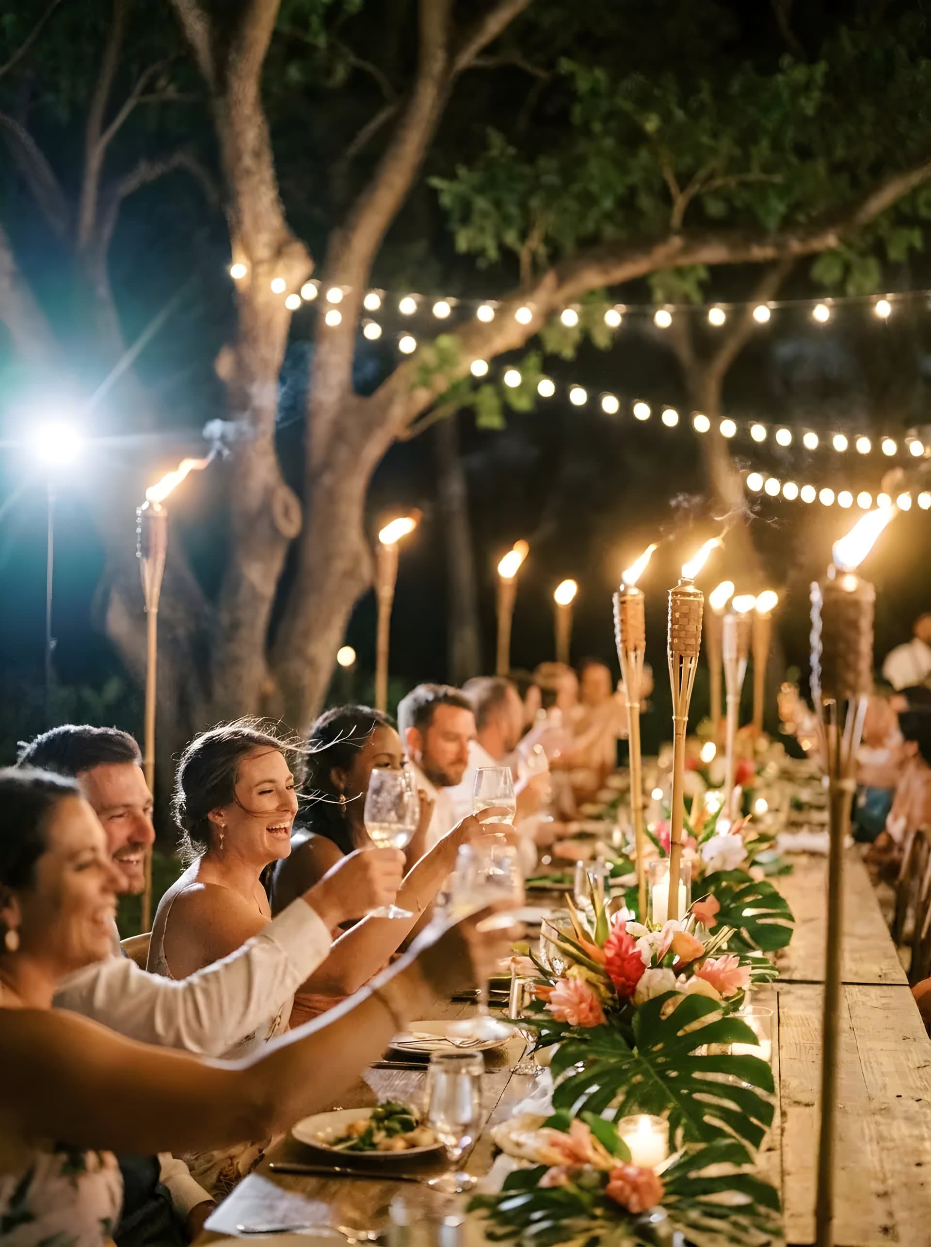 Dance floor packed with guests under string lights