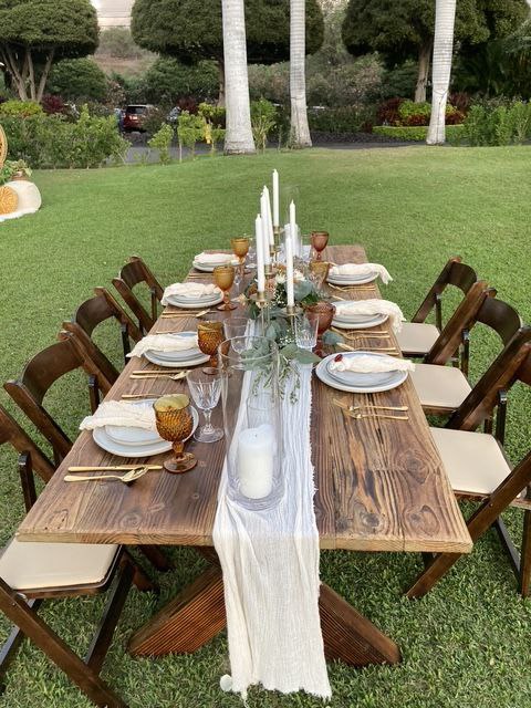 Rustic farm table wedding reception setup on Maui