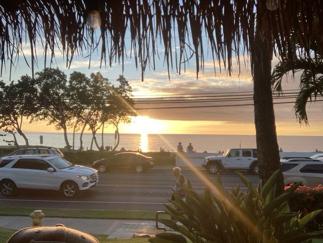 Oceanfront tiki bar during golden hour on Maui