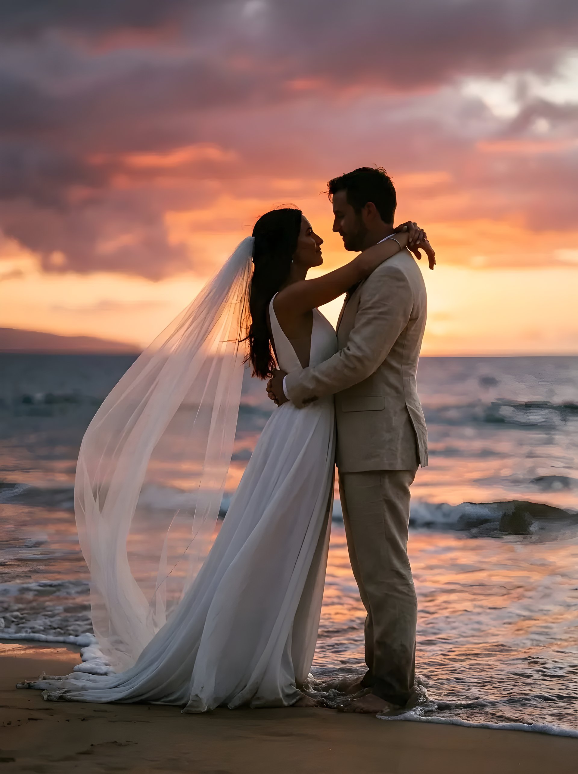 Newlywed couple walking along Makena Beach at sunset